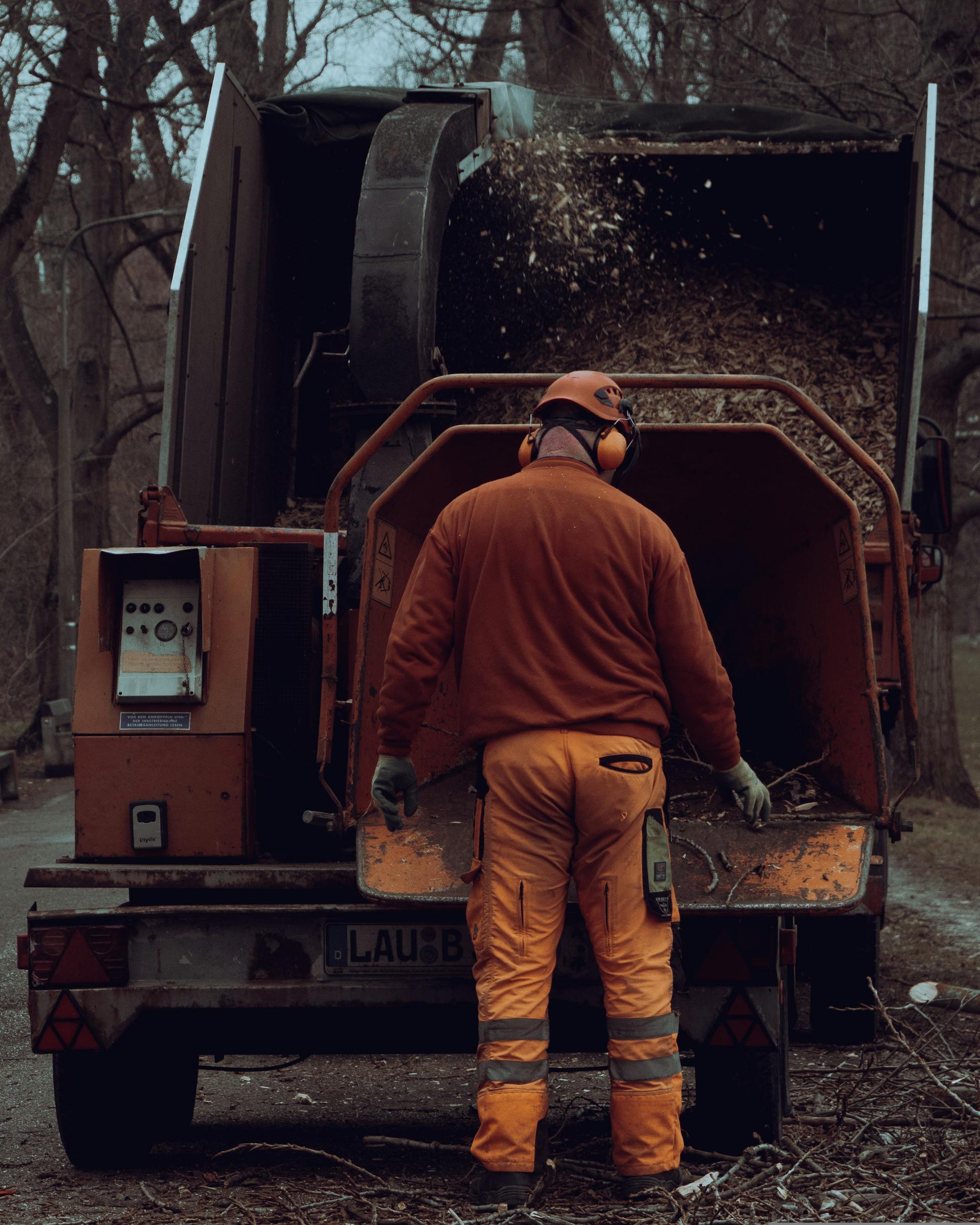 Yonkers Tree Experts crew member working with a wood chipper