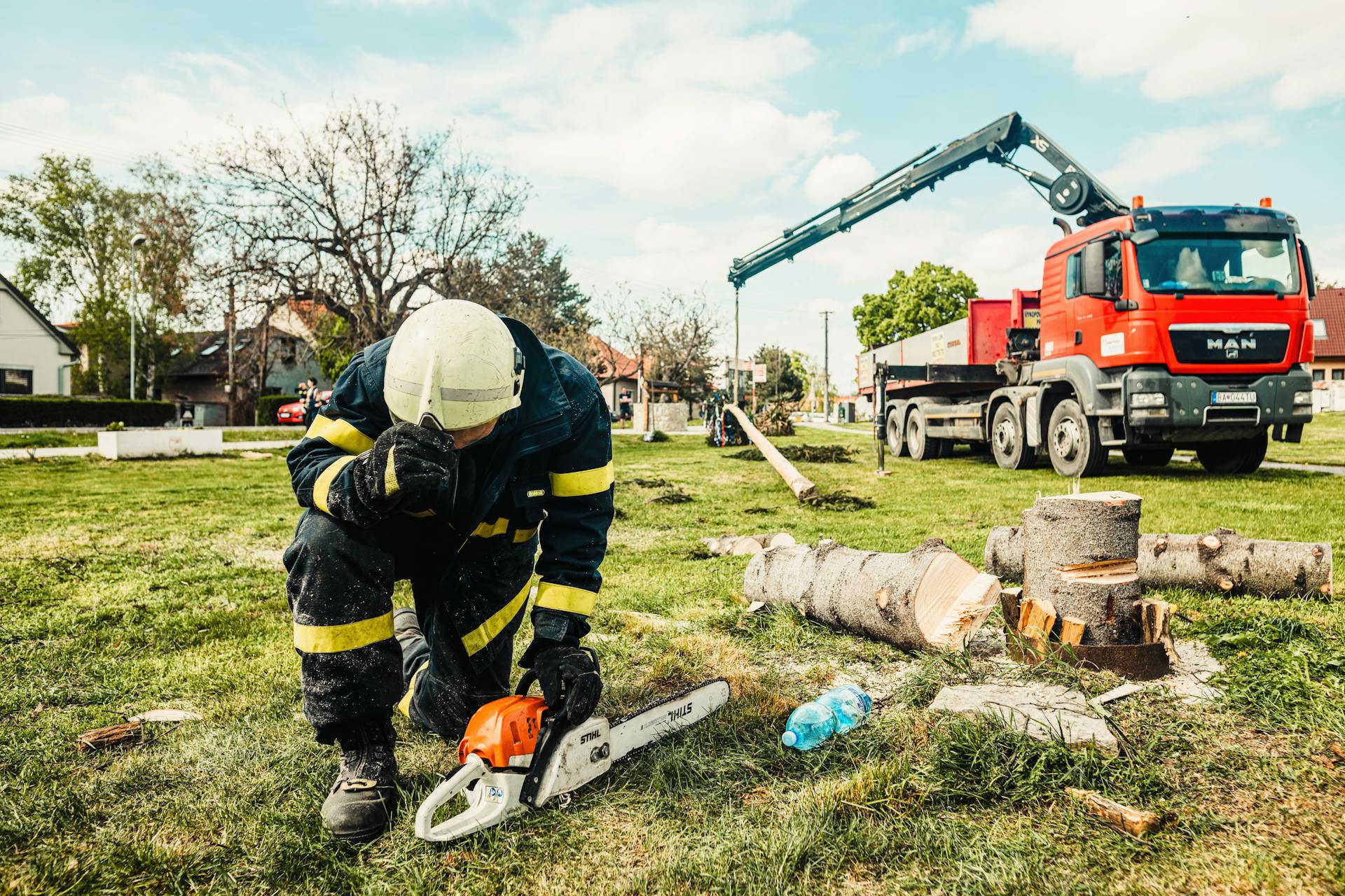 Yonkers Tree Experts crew member with chainsaw beside service truck