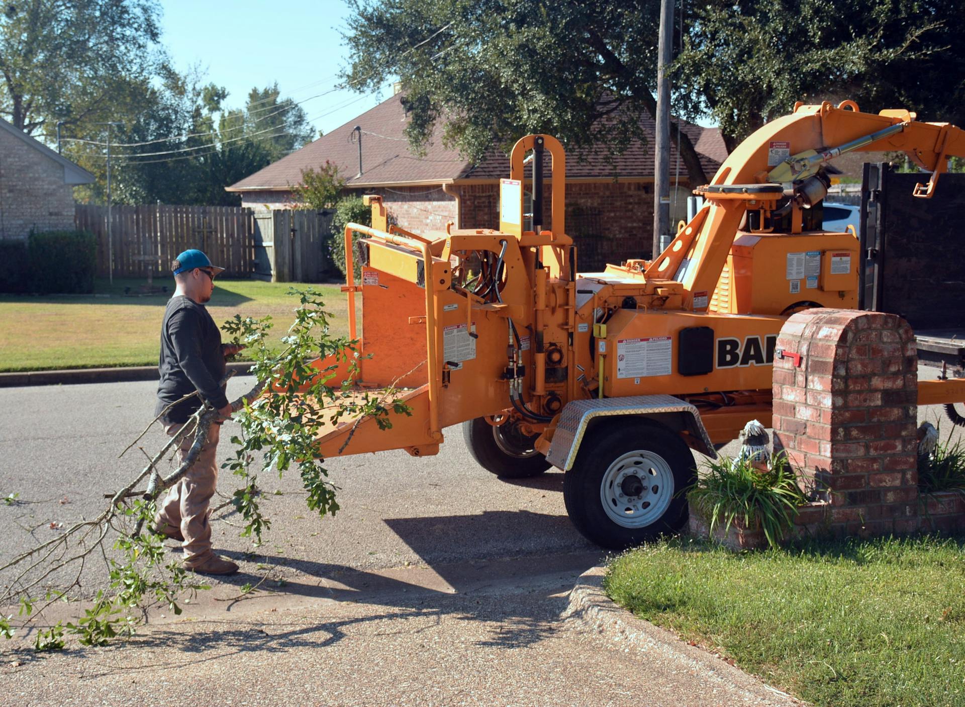 Tree service crew operating wood chipper in a Yonkers neighborhood